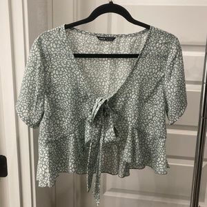 light green leopard top, ties in front